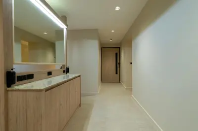 a bathroom with a counter and a hallway at The Chedee Krungthep in Bangkok
