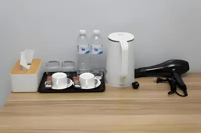 a tray with cups and water bottles on a desk at XX GO INN BTS Nana Sukhumvit Soi 3 x โกอินน์ บีทีเอส นานา ซอย 3 in Makkasan