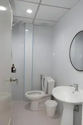 a bathroom with a toilet and a sink and a mirror at XX GO INN BTS Nana Sukhumvit Soi 3 x โกอินน์ บีทีเอส นานา ซอย 3 in Makkasan