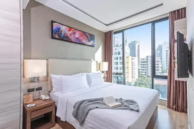 a hotel room with a bed with a book on it at Adelphi Forty-Nine in Bangkok