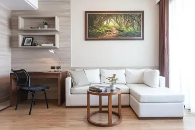 a living room with a white couch and a desk at Adelphi Forty-Nine in Bangkok