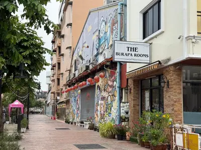 a building with a sign that reads the bazar rooms at The Burapa Rooms in Bangkok