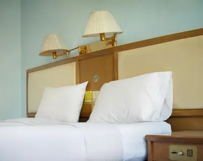 a bed with two white pillows and two lights above it at xx Wish Inn Chidlom - วิช อินน์ ชิดลม ราชดำริ 2 in Pratunam