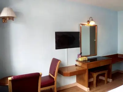 a hotel room with a desk and a mirror at xx Wish Inn Chidlom - วิช อินน์ ชิดลม ราชดำริ 2 in Pratunam