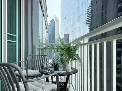 a balcony with a table with a plant on it at Roomy Modern 2BR - Ultra Fast WiFi - BTS Phrom Phong in Bangkok