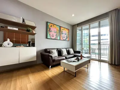 a living room with a couch and a table at Roomy Modern 2BR - Ultra Fast WiFi - BTS Phrom Phong in Bangkok
