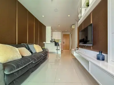 a living room with a black leather couch and a television at Luxurious High-Rise - Ultra Fast Wifi - MRT Petchaburi in Bangkok