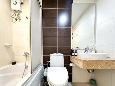 a bathroom with a toilet and a sink and a tub at Upscale Expansive 2BR - Ultra Fast Wifi - Phrom Phong in Bangkok