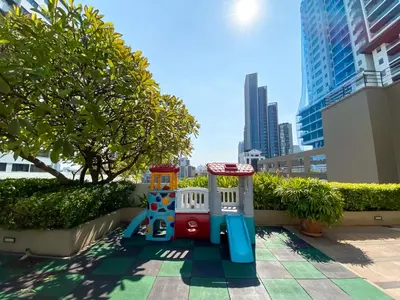 a toy train on a sidewalk in a city at Upscale Expansive 2BR - Ultra Fast Wifi - Phrom Phong in Bangkok