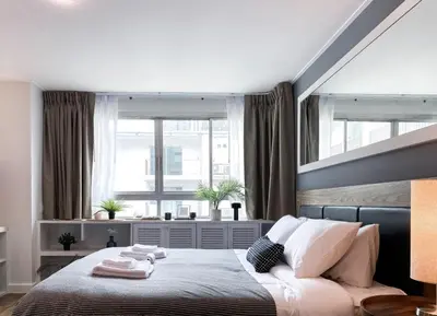 a bedroom with a bed and a large window at Exclusive Urban Apt 1BR - Ultra Fast Wifi - Thong Lo in Bangkok