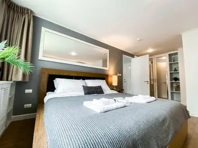 a bedroom with a large bed with two towels on it at Exclusive Urban Apt 1BR - Ultra Fast Wifi - Thong Lo in Bangkok