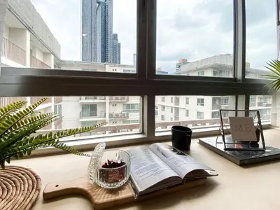 an open book on a table in front of a window at Exclusive Urban Apt 1BR - Ultra Fast Wifi - Thong Lo in Bangkok