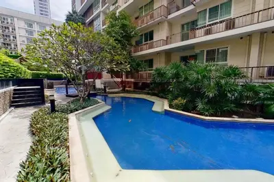 a large blue swimming pool in front of a building at Exclusive Urban Apt 1BR - Ultra Fast Wifi - Thong Lo in Bangkok