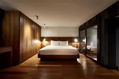 a bedroom with a large bed in a room at Wish Inn Silom - วิช อินน์ สีลม in Bang Rak