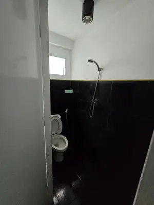 a bathroom with a toilet and a shower at Jatujak Bangkok guesthouse R 03-06 in Sathani Bang Su
