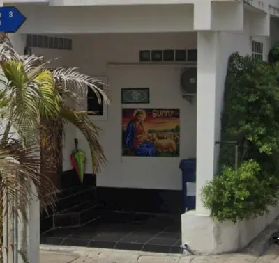 a building with a painting on the side of it at Jatujak Bangkok guesthouse R 03-06 in Sathani Bang Su