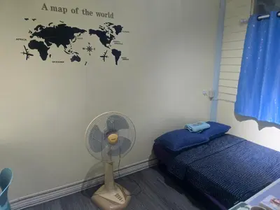 a room with a fan and a map of the world at 209 Beautiful and Cozy apartment near skytrain & WiFi in Bangkok