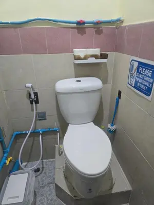 a bathroom with a white toilet in a room at 209 Beautiful and Cozy apartment near skytrain & WiFi in Bangkok