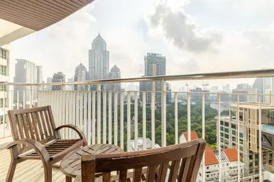 a balcony with two chairs and a view of a city at 2Br, Good view, BTS Chitlom, BKK in Bangkok
