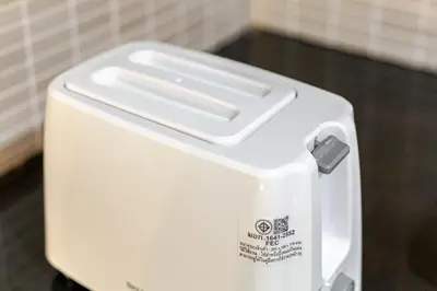 a white toaster sitting on top of a table at Large room with 2Beds BTS Chitlom Sukhumvit BKK in Bangkok