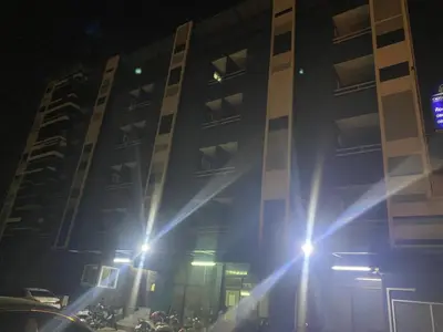 a tall building with lights in front of it at night at Ordinary Salaya in Sathani Sala Ya