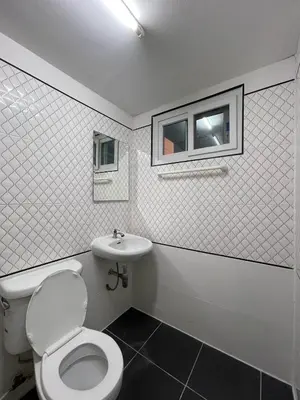 a bathroom with a toilet and a sink at Ordinary Salaya in Sathani Sala Ya