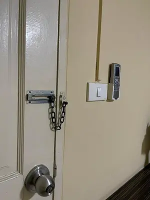a door with a cell phone attached to it at Ordinary Salaya in Sathani Sala Ya