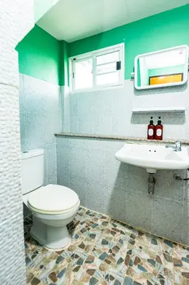 a bathroom with a toilet and a sink at xx GO INN The Giant Swing เสาชิงช้า กรุงเทพ in Bangkok