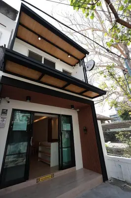 a house with a glass door and a porch at Risa Hostel - Female Only for Solo Travelers in Bangkok