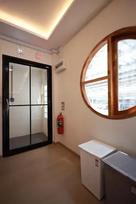 a room with a glass door and a window at Risa Hostel - Female Only for Solo Travelers in Bangkok
