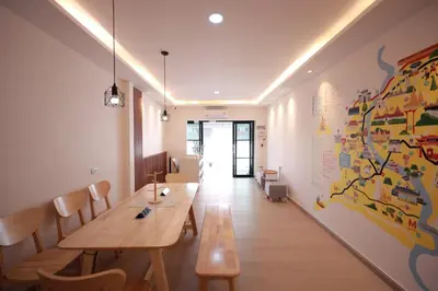 a dining room with a wooden table and chairs at Risa Hostel - Female Only for Solo Travelers in Bangkok