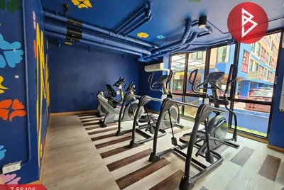 a gym with tread machines in a blue room at MeStlye BangNa - Baan Win in Bangna