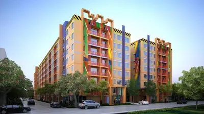 a colorful building with cars parked in front of it at MeStlye BangNa - Baan Win in Bangna