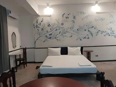 a bedroom with a bed and a painting on the wall at xx The Character Yaowarat เดอะ คาแรคเตอร์ เยาวราช ตรอกข้าวสาร in Samphanthawong