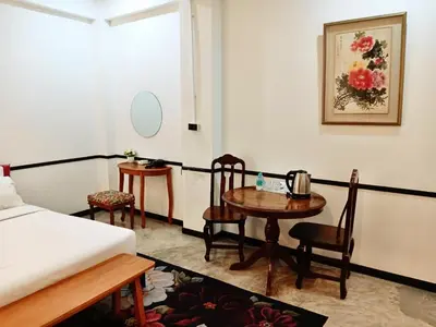 a bedroom with a bed and a table and chairs at xx The Character Yaowarat เดอะ คาแรคเตอร์ เยาวราช ตรอกข้าวสาร in Samphanthawong
