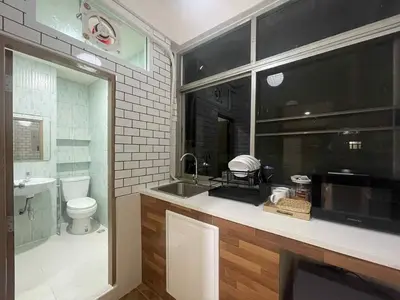 a bathroom with a sink and a toilet at Dime Rama III in Bangkok