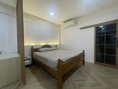 a small bedroom with a bed and a window at Dime Rama III in Bangkok