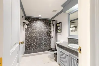 a bathroom with a shower with a toilet and a sink at Cozy 2BR Apt in Central Bangkok 5 mins BTS 110 SQM by MattCo in Bangkok