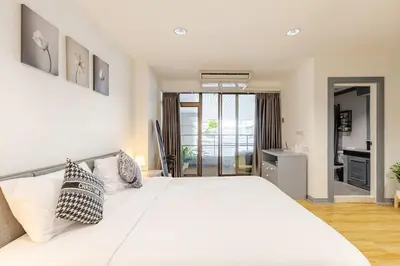 a bedroom with a large white bed with pillows at Cozy 2BR Apt in Central Bangkok 5 mins BTS 110 SQM by MattCo in Bangkok