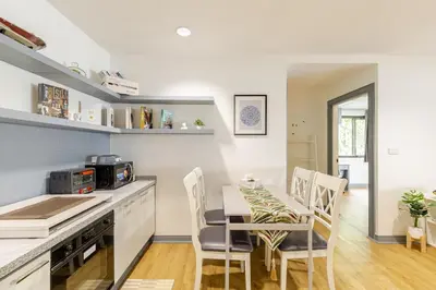 a kitchen and dining room with a table and chairs at Cozy 2BR Apt in Central Bangkok 5 mins BTS 110 SQM by MattCo in Bangkok