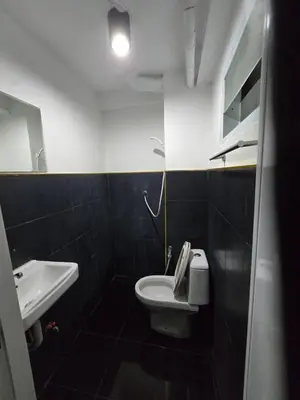 a bathroom with a white toilet and a sink at Jatujak Bangkok guesthouse in Sathani Bang Su