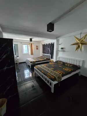 a bedroom with two beds and a star on the wall at Jatujak Bangkok guesthouse in Sathani Bang Su