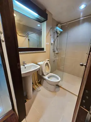 a bathroom with a toilet and a sink and a shower at Mrchow Nana in Bang Kapi