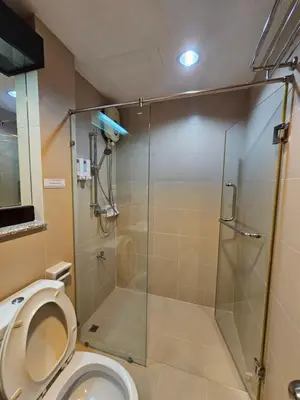 a bathroom with a shower and a toilet at Mrchow Nana in Bang Kapi