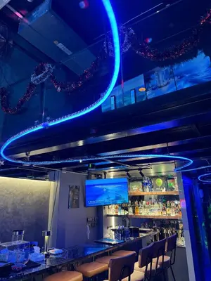 a bar in a restaurant with blue lights at Mrchow Nana in Bang Kapi