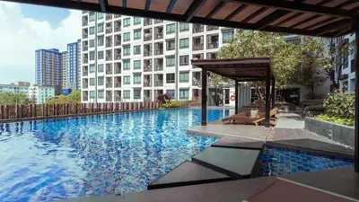 a swimming pool in the middle of a building at Cosy & Bright 1 bedroom in Bangkok