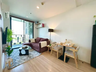 a living room with a couch and a table at Cosy & Bright 1 bedroom in Bangkok