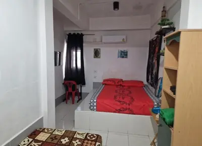 a bedroom with a bed with a red blanket at Jatujak Bangkok guesthouse R8 in Sathani Bang Su