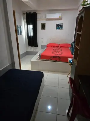a bedroom with a bed with a red blanket at Jatujak Bangkok guesthouse R8 in Sathani Bang Su