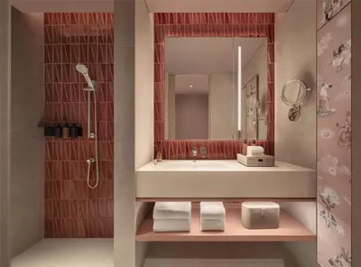 a bathroom with a sink and a mirror at Kromo Bangkok, Curio Collection By Hilton in Bangkok